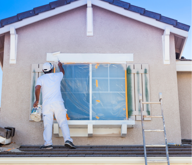 Man painting fixaxion house